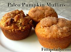 three muffins on a plate with the words paleo pumpkin muffins