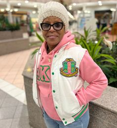 Unisex size, go down a size. -White nylon with pink stitching -Pink and green ribbing with Sherpa lining -Green buttons -Chenille Embroidered Applique Logo hooded Final Sale Item- Discount codes no allowed on discontinued items. No refunds or exchanges. Pink Cotton Outerwear With Fleece Lining, Pink Varsity Outerwear For Winter, Pink Varsity Winter Outerwear, Pink Cotton Varsity Outerwear, Pink Embroidered Casual Outerwear, Casual Pink Embroidered Outerwear, Casual Pink Hoodie With Fleece Lining, Alpha Kappa Alpha Clothing, Aka Apparel