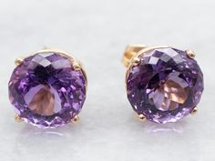 These amethyst studs make a bold statement on the ear! Sparkling in shades of grape and lilac, these gemstones command attention and look fabulous against settings of bright yellow gold. Classic, yet glamorous! Metal: 14K Yellow Gold Gem: 2 Amethyst totaling 8.75 Carats Gem Measurements: 10.0 mm, Round Marks: "14K" Stamped SKU #: A48672 Each piece has been identified and graded by a Graduate Gemologist who has been certified by the Gemological Institute of America (GIA). We have six brick-and-mortar storefronts in Maine, Massachusetts, and New Hampshire and have been in business for over 25 years! Please visit our Shop's About Page or our website for more information about our jewelry. For questions about diamond grading, we recommend the  Gemological Institute of America (GIA), the founde Statement Stud Earrings, Pretty Accessories, Amethyst Studs, February Birthstone, Earrings Stud, Amethyst Earrings, February Birth Stone, Bright Yellow, New Hampshire