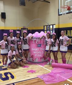 the cheerleaders are posing for a photo in front of a giant pinata