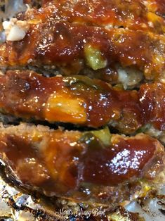 the meatloaf is covered with sauce and vegetables