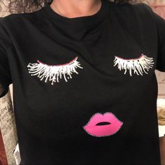 Brand New, Boutique Item Just In! Embellished Eyelashes And Lips With Rhinestones. Super Cute Black Or White T-Shirt With Eyelashes And Lip Design. See Other Listing For The White Tees! Measurements Shown On Small Size, See Pics. Other Brands In My Closet: Avon, Ann Taylor, B. Darlin, Beanie Babies, Betsey Johnson, Bebe, Blue Cat, Blue Rain, Brighton, Bronson Collectibles, Cartoon Network, Chicos, Cloisonn, Coach, Converse, Cookie Lee, Crayola, Danica Studio, Disney, Elle, Elliott, Estate, Franc Black Rhinestone T-shirt For Party, Trendy Black Tops With Rhinestone Fringe, Black T-shirt With Rhinestones For Party, Party T-shirt With Rhinestones And Short Sleeves, Black Embellished T-shirt For Party, Casual Embellished T-shirt For Party, Embellished T-shirt For Party, Blue Rain, Blue Cat