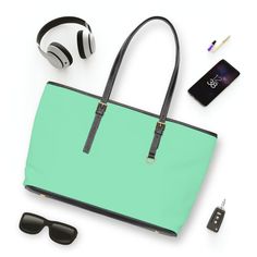 Large Leather Tote Shoulder Bag, Seafoam Green. This versatile tote bag is tailored for the modern woman who prioritizes practicality and style. This bag was created with a large interior and well-thought-out compartments, this tote effortlessly caters to your needs for any occasion. Designed with functionality in mind, it seamlessly blends into your busy lifestyle while making a fashion-forward statement. This tote allows you to showcase your individuality effortlessly. Lightweight yet sturdy, Green Casual Office Bag, Green Tote Shoulder Bag For Office, Modern Laptop Shoulder Bag For Shopping, Functional Rectangular Shoulder Bag For Shopping, Green Shoulder Laptop Bag For Daily Use, Functional Rectangular Satchel For Shopping, Green Shoulder Laptop Bag For Everyday Use, Green Satchel Laptop Bag For Everyday, Trendy Green Bags With Leather Handles