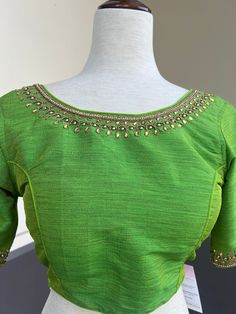 Parrot Green Color Raw Silk Readymade Blouse with beautiful Handwork Work. Item : Readymade BlouseSize : 36 (Can be opened to Size 40)Length of the Blouse : 14 inches Length of the Sleeves : 10 inches Color : Parrot Green Blouse Fabric : Soft Silk Lining : Yes, it is fully lined Padded or Non-Padded : PaddedClosure: Back Closure with hooks.Ready-to-Wear : YesDisclaimer - : -This is a Standard Size blouse. We do not guarantee perfect fit as every body and shape is different. Little or no alterati Diwali Short Sleeve Self Design Blouse, Diwali Themed Self-design Short Sleeve Blouse, Diwali Short Sleeve Blouse With Zari Work, Diwali Short Sleeve Semi-stitched Blouse, Festive Designer Short Sleeve Blouse, Festive Green Traditional Wear With Short Sleeves, Elegant Short Sleeve Top With Self Design, Semi-stitched Blouse With Pallu And Short Sleeves, Short Sleeve Cutdana Blouse For Festive Occasion