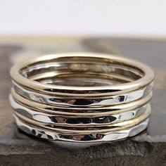 This Smooth Gold & Hammered Sterling stacking ring set is entirely hand-made & mixes well with most of the items in our store. * This listing is for one 6-band set: 3 Hammered Sterling bands & 3 Polished Gold-filled bands. * Made with: 16g (1.29 mm) 12k Yellow Gold-filled & Sterling Silver wire. * When stacked, they measure at about 7 rings per half inch. * All of our items are entirely hand crafted and have a standard processing time of 3-5 Business days to make the order. * Items are processed Stacked Round Rings For Anniversary, Stacked Round Rings As Gift, Stack Rings, Sweet Jewelry, Beaded Jewels, Stack Ring, Stacking Ring Set, Gold And Silver Rings, Solid Gold Earrings