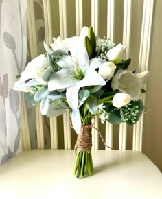 a bouquet of white flowers sitting on top of a table