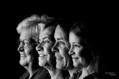 black and white photograph of four women smiling