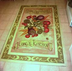 a kitchen area with a rug on the floor that says long & kitchen, surrounded by fruits and vegetables