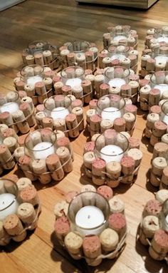 many candles are arranged on the floor in rows and placed next to each other with cork wrapped around them