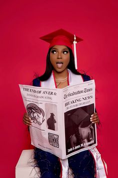 a woman sitting on top of a toilet while reading a newspaper with a graduation cap on her head