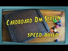 the card board dm - screen speed build is shown with dices and beads