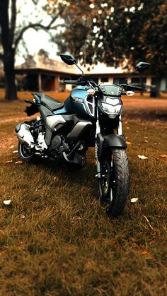 a motorcycle parked on top of a lush green field