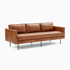 a brown leather couch with metal legs