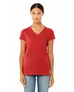 a woman wearing a red shirt and jeans