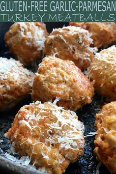 baked meatballs with grated parmesan cheese on top in a frying pan