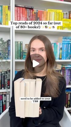 a woman sitting in front of a bookshelf holding two stacks of books with the caption top reads of 2012 so far out of 60 books i need to be added to your tik