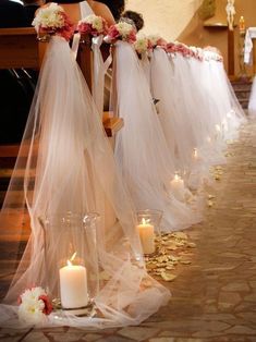 the bride and groom are sitting in chairs with their wedding veils draped over them