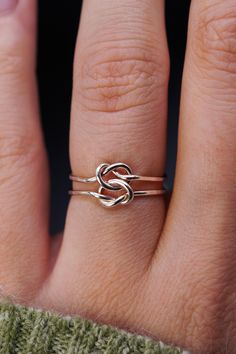 This double love-knot is the perfect gift for Valentine's Day! Made up of two individual rings that are permanently connected, this tied ring is a classic and gorgeous gift to symbolize your loved one. This listing is for a SINGLE Ring. Made in 14k Gold Fill, Rose Gold Fill or Sterling Silver. Made in out signature Thick 1mm metal. Please note that the knot ring style has a slight faceted or hammered finish, it is not completely smooth. Each piece is organic and unique, no two Hannah Naomi pieces are exactly alike. Handmade to order in our Portland, OR Studio. * * * * * * * * * * * * * * * * * * * * * * * See a full description of all the shipping services I offer (domestic and international) in my Policies section here: http://www.etsy.com/shop/hannahnaomi/policy * * INTERNATIONAL CUSTOME Intertwined Ring, Love Knot Ring, Double Knot, Infinity Ring, Knot Ring, Gold Ring Stack, Ring Style, One Ring, Gorgeous Gift