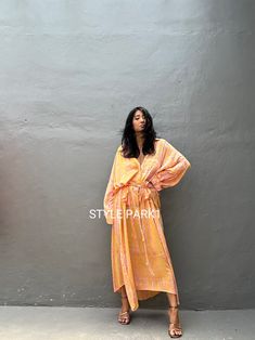 Jimbaran dress  is an oversized long sleeve soft rayon voile Long shirts  dress  .  This Oversized shirt dress is designed to flatter every body type and fit numerous occasions. 👍Included tali - f e a t u r e s - - Relaxed fit - Front pockets Fabric: 100% Soft rayon voile  Style:oversized fit Color:Bali Hand tie dyed peach & multi motif Wash :Hand cool wash  - measurement -  - One size  -  I recommend American size M to XL Chest /164cm/ 64inch(round) Length/135cm/53inch Transparent - it's  tran Flowy Long Sleeve Dresses For Beach Cover-up, Oversized Long Sleeve Tunic For Beach Cover-up, Orange Long Sleeve Maxi Dress For Vacation, Orange Long Sleeve Maxi Dress For Summer, Oversized Orange Dresses For Spring, Relaxed Fit Long Sleeve Maxi Dress For Daywear, Summer Long Sleeve Tunic For Brunch, Long Sleeve Summer Maxi Dress For Daywear, Flowy Long Sleeve Beach Cover-up Dress