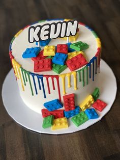 a cake decorated with legos and the words kevin painted on it's side