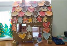 a house made out of cardboard and decorated with gingerbreads