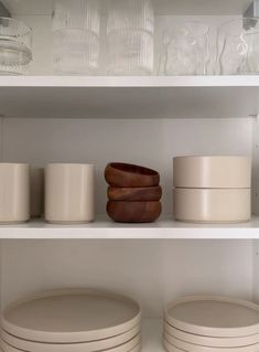 white dishes and bowls on shelves in a kitchen