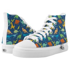 Colorful Dinosaur silhouette pattern. Tyrannosaurus Rex, titanosaurs, Triceratop, raptors, Ankylosaurs, Dino-Birds, Stegosaurus, Apatosaurus, Pteranodon and more in a colorful pattern in blue background, and dinosaurs in green, blue, yellow and orange. Dino Shoes, Sneaker Gift Ideas, Mexican Embroidery Designs, Dinosaur Shoes, Sneakers Colorful, Women Sneakers Fashion, High Top Tennis Shoes, Colorful Dinosaur, Dinosaur Silhouette