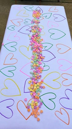 a long table with hearts and confetti on it