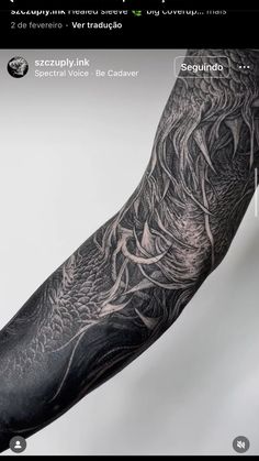 the arm is covered in black ink and has an intricate dragon design on it's left