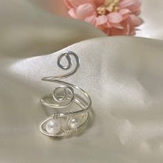 "This Wire Wrapped  Silver Ring is a unique an perfect gift, made with  4mm pearl and wrapped in non tarnish silver wire. Can be adjustable and is a perfect choice for an everyday outfit or any special occasion. Surprise your wife, girlfriend, best friend, bridesmaid or even yourself with this beautiful ring and make them feel how special they are for you. You can also ask for a different wire color (silver or gold tone are available). Feel free to send me a message if you have any question or s Dainty Hand-wrapped Silver Rings, Adjustable Pearl White Pearl Ring As A Gift, Elegant Adjustable Wire Wrapped Pearl Ring, Elegant Wire Wrapped Metal Rings, Elegant Metal Wire Wrapped Rings, Elegant Wire Wrapped Toe Rings, Elegant Wire Wrapped Ring As Gift, Elegant Wire Wrapped Rings For Gifts, Elegant Wire Wrapped Ring For Gift