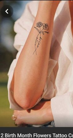 a woman's arm with a flower tattoo on her left forearm and the words, birth month flowers tattoo written in cursive