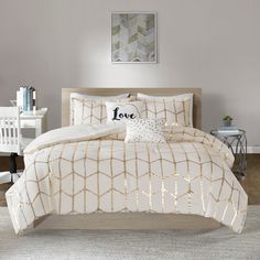 a bed with white and beige comforters in a room