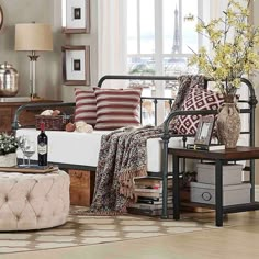 a living room filled with lots of furniture and decor on top of a hard wood floor