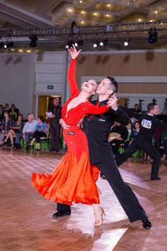 two people are dancing on the dance floor