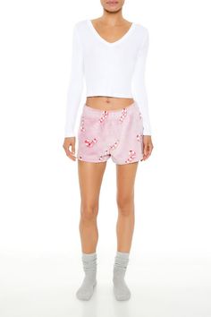 Pair of plush knit shorts featuring an allover candy cane print and elasticized waist. | 100% polyester | Hand wash cold | Model is 5'9" and wearing Small | Plush Candy Cane PajamShorts Casual Relaxed Fit Shorts For Pajama Party, Relaxed Fit Shorts For Pajama Party, Relaxed Fit Shorts For Sleepover, Casual Pajama Shorts With Elastic Waistband For Pajama Party, Sleepover Pajama Shorts With Elastic Waistband, Casual Shorts For Pajama Party, Casual Shorts With Elastic Waistband For Sleepover, Casual Elastic Waistband Shorts For Sleepover, Cozy Pajama Shorts With Elastic Waistband