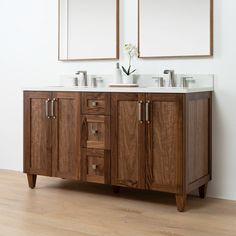 two mirrors are above the double sink vanity