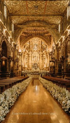 the interior of an old church with flowers on the pews