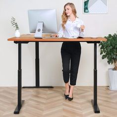 a woman sitting at a desk with a computer