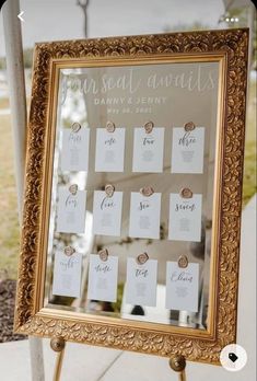 a gold framed mirror sitting on top of a wooden stand next to a sign that says instead animals