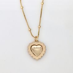 Stunning authentic Gucci heart-shaped pendant with classic interlocking GG logo in light champagne gold tone with elegant faux pearl detail. Product details: necklace length: 17.9 inches necklace material: 18k gold plated satellite chain pendant measurements: 20mm pendant is stamped "GUCCI" for authenticity Gold-tone Logo Plaque Pendant Necklace, Designer Necklace With Adjustable Chain For Gift, Elegant Gold Necklace With Logo, Elegant Gold-tone Logo Plaque Pendant Jewelry, Elegant Gold-tone Pendant Jewelry With Logo Plaque, Elegant Gold-tone Necklace With Logo Charm, Elegant Pendant Jewelry With Gold-tone Logo Plaque, Elegant Gold Plated Jewelry With Logo Charm, Elegant Gold-tone Pendant Jewelry