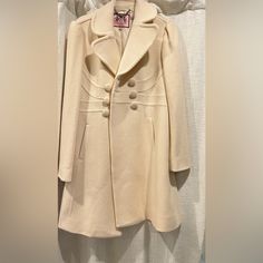 This Is A Brand New Juicy Couture Knee Length Double Breasted Wool Coat, Extra Buttons On The Inside Lined Coat Made Of Wool And Cashmere Never Worn.. I Am 5 Foot Seven, 140 Pounds For Reference Bust Pit To Pit 18". Waist Is Approximately 16.5" Across Laying Flat. Length Is Approximately 35". Sleeve 24.5 70% Wool / 20% Poly / 10% Cashmere Tailored Designer Long Sleeve Wool Coat, Luxury Cream Blazer For Winter, Designer Single Breasted Wool Coat, Designer Long Sleeve Wool Coat For Office, Designer Single-breasted Wool Coat, Elegant Double-breasted Cream Wool Coat, Chic Cream Pea Coat For Formal Occasions, Fitted Beige Pea Coat For Winter, Cream Wool Coat For Winter Office Wear