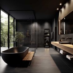 a bathroom with a large black bathtub next to a walk in shower and sink