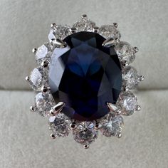 an oval blue diamond surrounded by smaller white diamonds