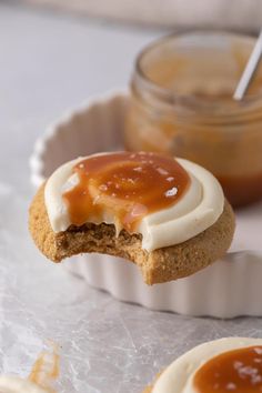 an open cookie with caramel sauce on it and another cupcake in the background