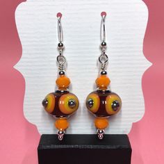 These earrings are made with beautiful red, orange and yellow lampwork beads, rondelle shaped orange Chinese crystals, sterling silver spacer beads and small round sterling silver beads dangling from sterling silver earwires. The earrings measure 1 3/4 inches from the top of the earwires. Click here to see other earrings in my shop: https://www.etsy.com/shop/JewelryDesignsByRita?section_id=14765680 I have been designing and making jewelry since 2010. I use only the highest quality materials such Orange Czech Glass Dangle Earrings, Orange Sterling Silver Jewelry With Round Beads, Orange Czech Glass Jewelry With Ear Wire, Orange Czech Glass Beaded Jewelry, Nickel-free Orange Beaded Dangle Earrings, Orange Beaded Earrings With Round Beads, Orange Round Beaded Earrings With Ear Wire, Orange Round Bead Earrings For Gifts, Nickel-free Orange Beaded Drop Earrings