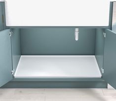 a white sink sitting inside of a blue cabinet