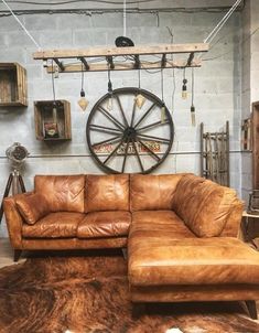 a brown leather couch sitting on top of a cowhide rug