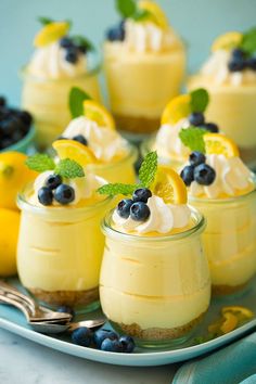 two pictures of desserts with lemon and blueberries in them, one is topped with whipped cream