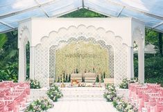 an outdoor wedding venue with pink and white decor