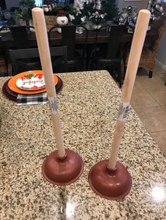 two candles are sitting on top of a table